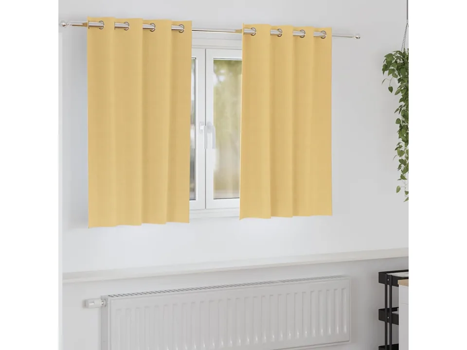 Yellow blackout curtains hanging on a rod over a window in a room.