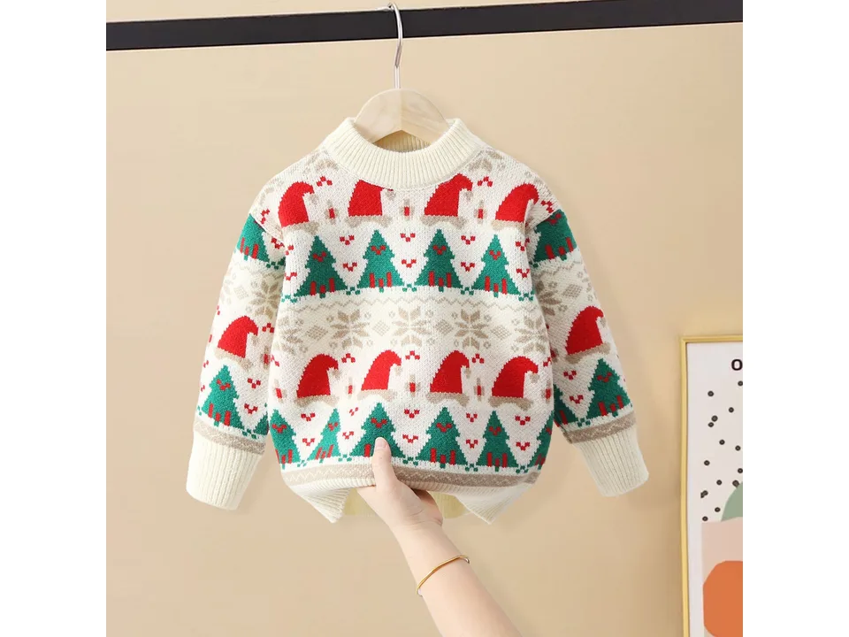 A white Christmas sweater with red and green tree and hat patterns held up against a beige background.