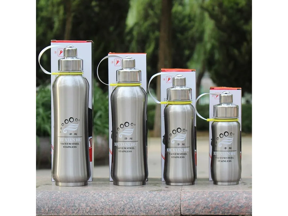Four stainless steel vacuum insulated water bottles of different sizes standing in a row.