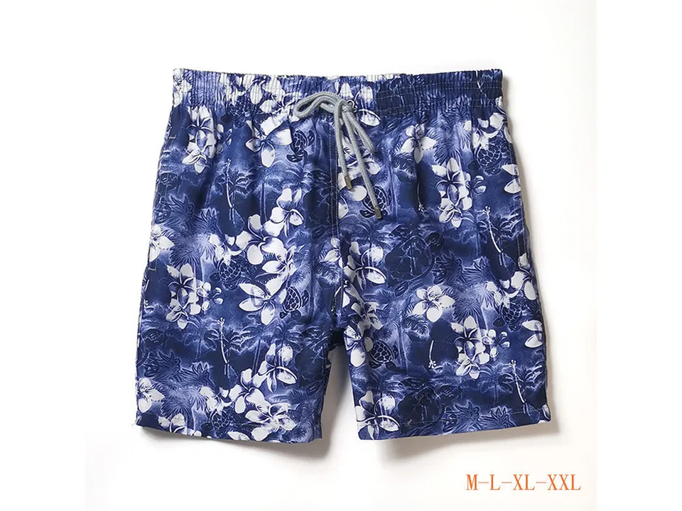 Blue floral and turtle print men's board shorts with drawstring.
