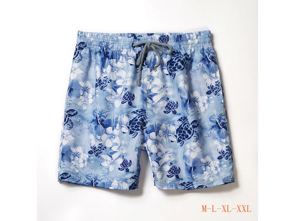 Light blue floral and turtle print men's board shorts with drawstring.