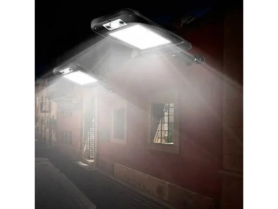 Two solar wall lamps illuminating a dark outdoor wall at night.
