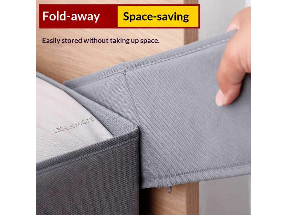 Close-up of a hand folding the side of a grey fabric storage box.