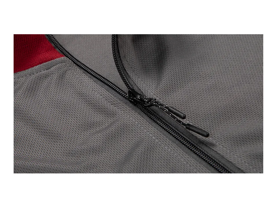 Close-up view of the grey sports suit fabric and zipper detail.