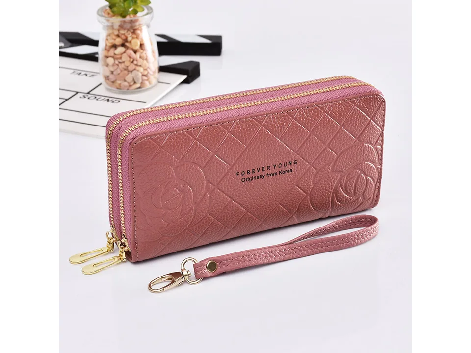 Dusty pink women's double zipper clutch wallet with floral pattern and wrist strap.