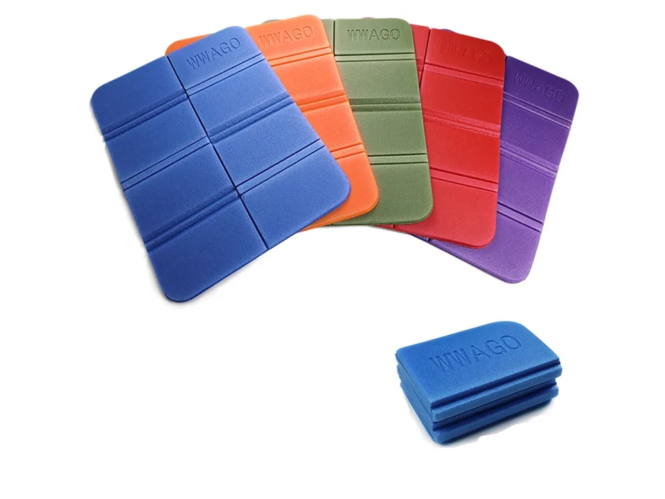 A collection of folding foam seat cushions in blue, orange, green, red, and purple, with one folded blue cushion.