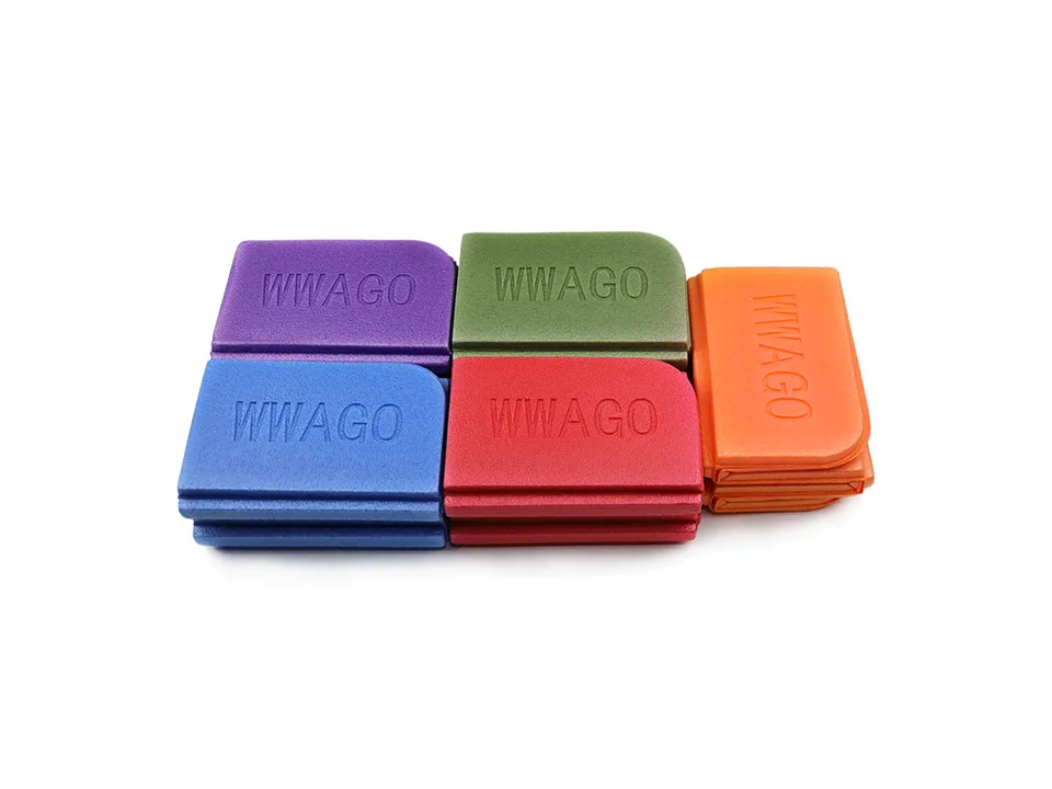 Five folded foam seat cushions in purple, green, orange, blue, and red stacked together.