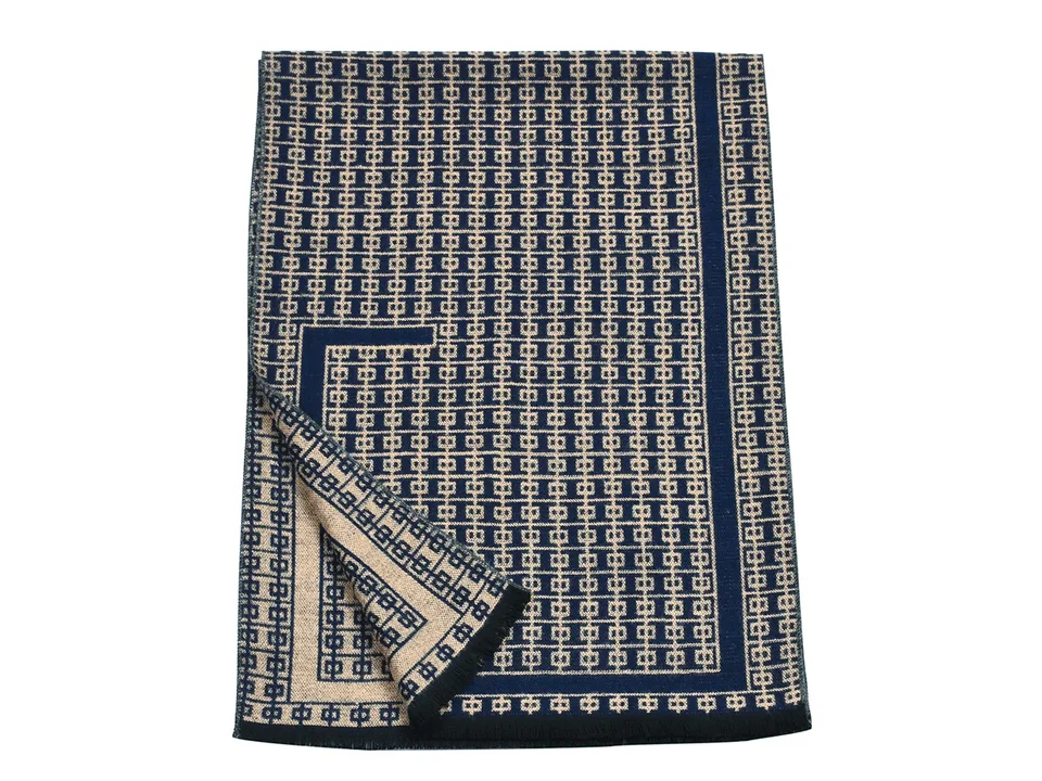 A blue and beige patterned scarf folded.