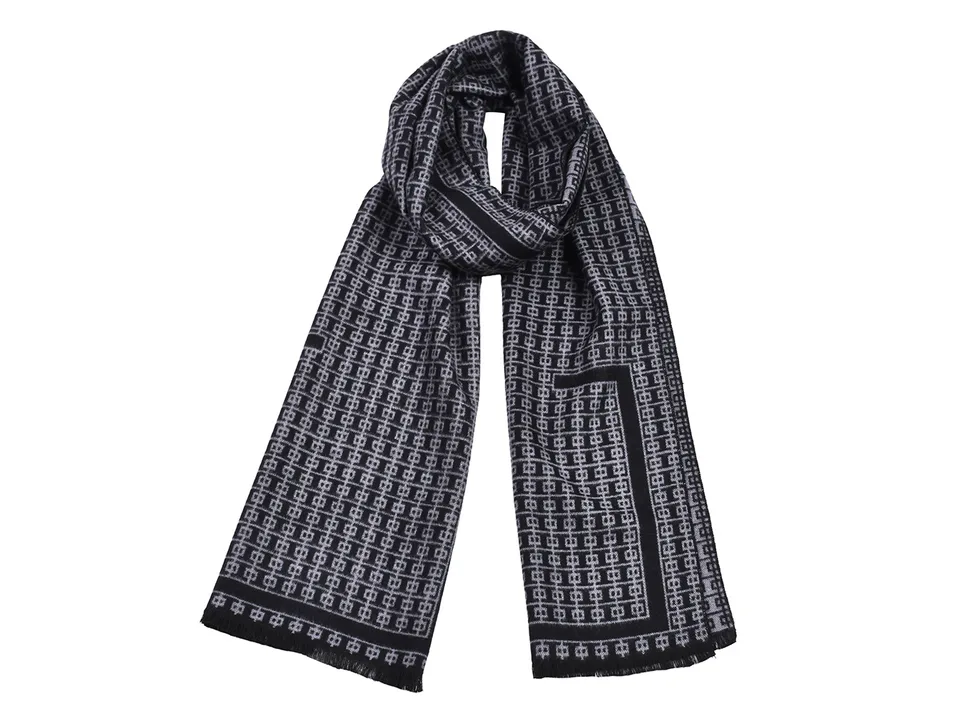 A grey and black patterned scarf with tassels.