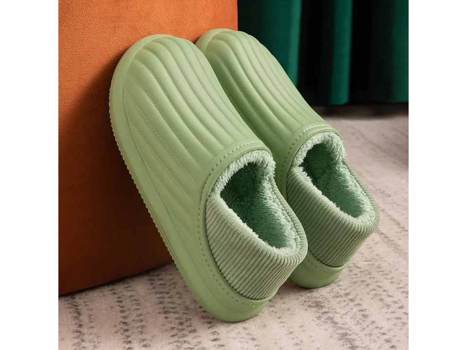 A pair of green plush thermal slippers.