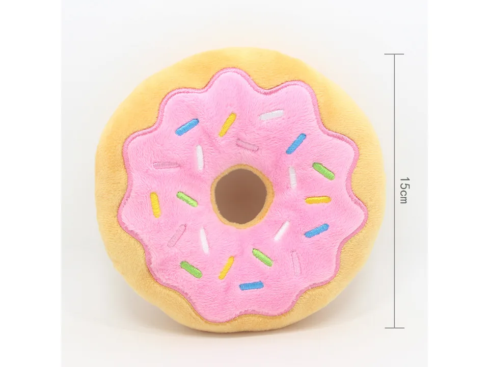 A pink-frosted plush donut toy with colorful sprinkles.