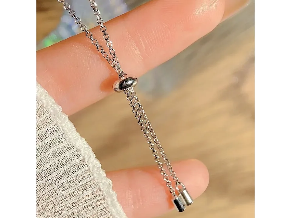 Close-up of the adjustable sliding clasp mechanism on the bracelet chain.