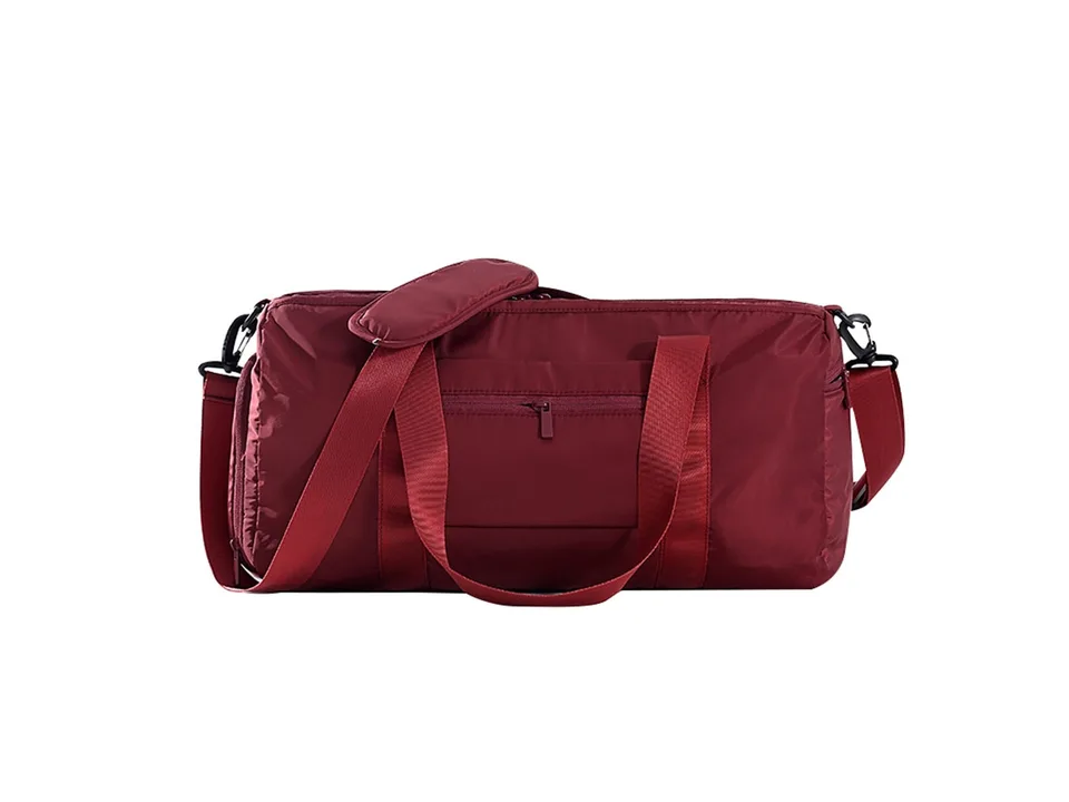 A red gym bag with shoulder strap and handles on a white background.