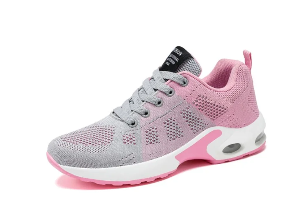 A pink and grey women's athletic sneaker with a white sole.