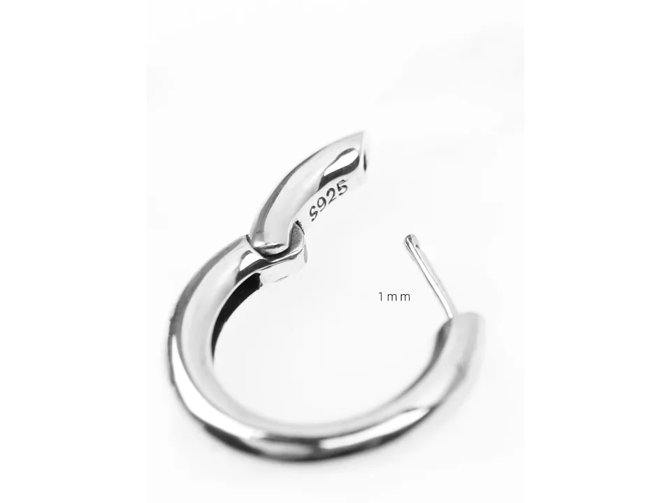 A silver hoop earring shown in an open position.