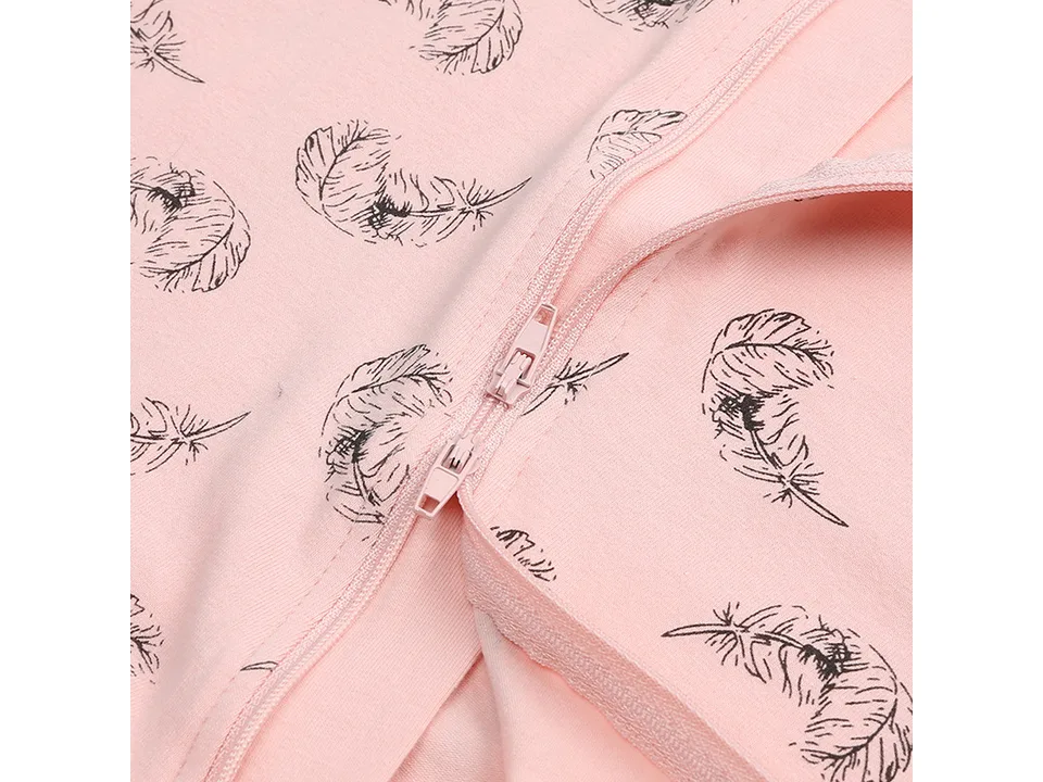 Close-up of the zipper closure on the pink feather-print jumpsuit.