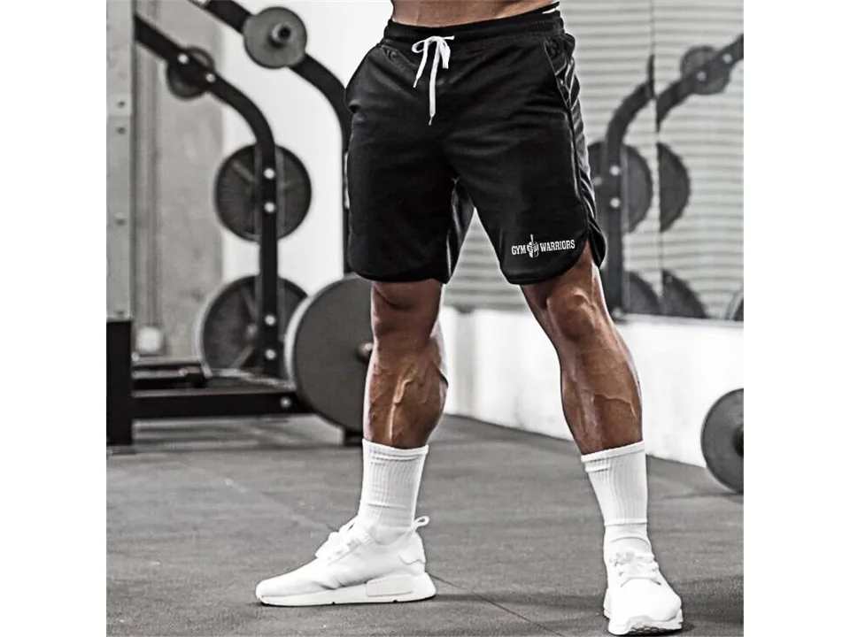 Close-up of a man wearing black athletic shorts with white drawstring.