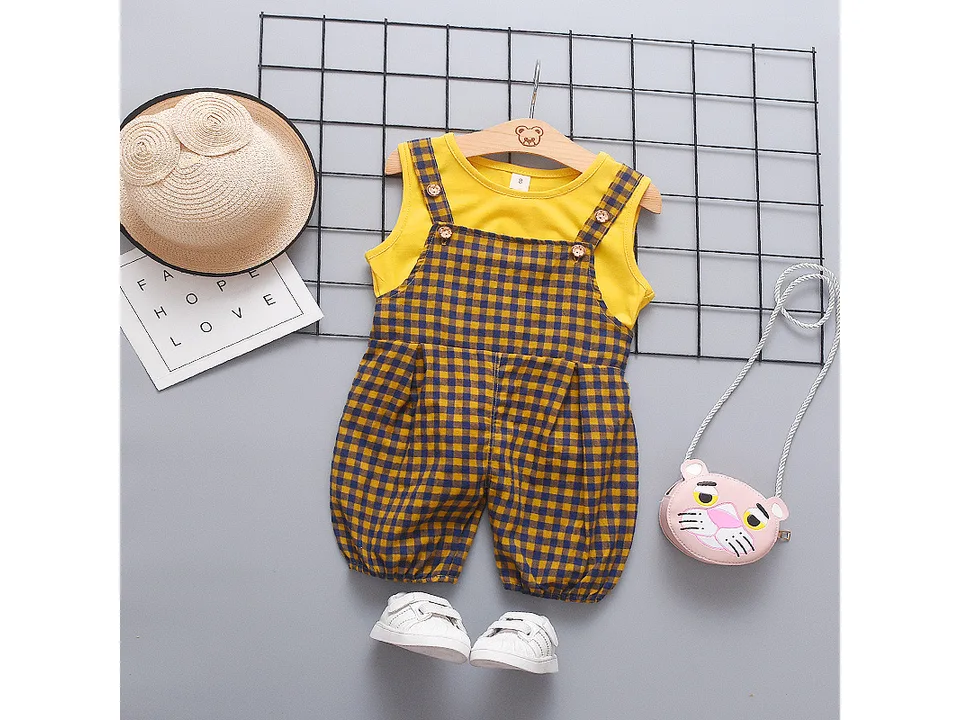 Yellow sleeveless top and plaid bib overalls set with a straw hat and small pink purse.