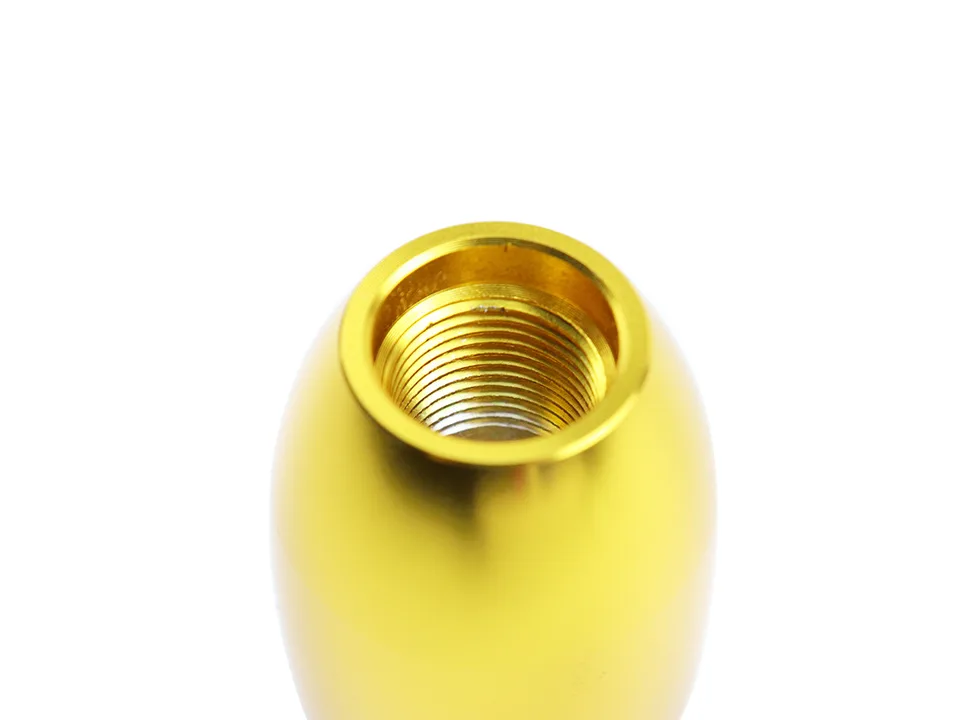 Close-up view of the internal threaded mounting hole of the gold gear shift knob.