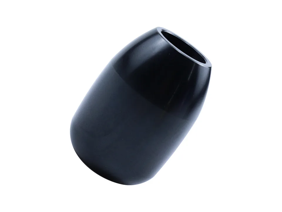 A black manual transmission gear shift knob isolated on a white background.