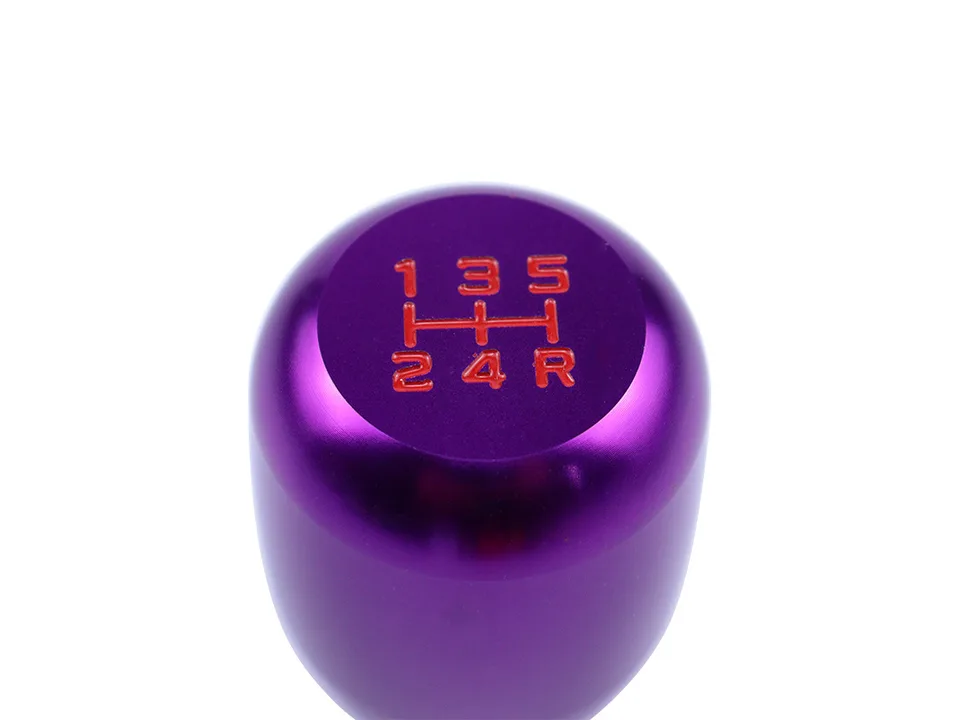 Top view of a purple gear shift knob showing the 5-speed manual transmission pattern in red.
