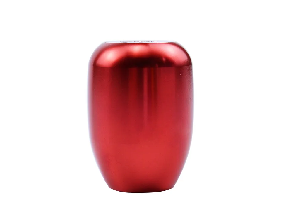 A red manual transmission gear shift knob isolated on a white background.