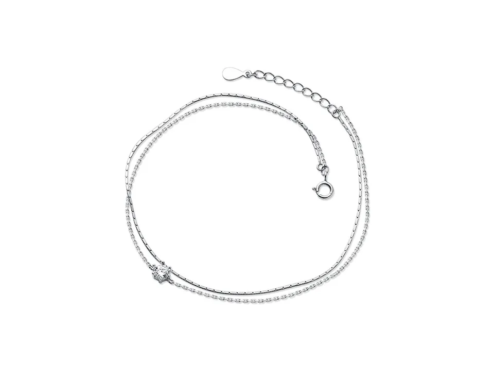 Silver double layer anklet with a single cubic zirconia charm on a white background.
