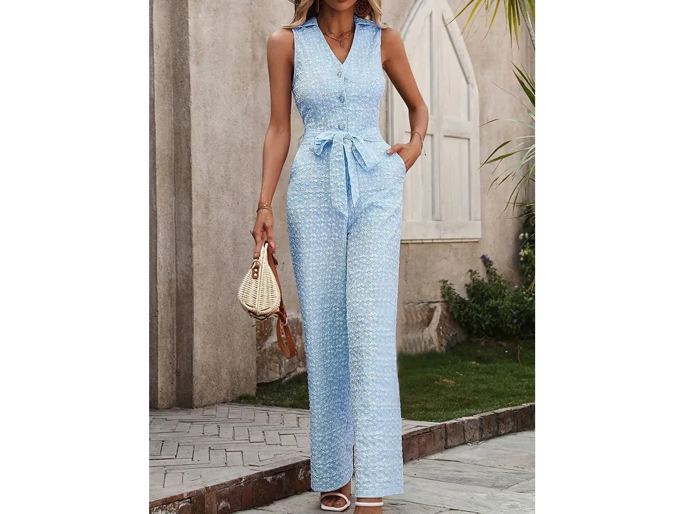 A model wearing a light blue sleeveless jacquard jumpsuit with a belt.