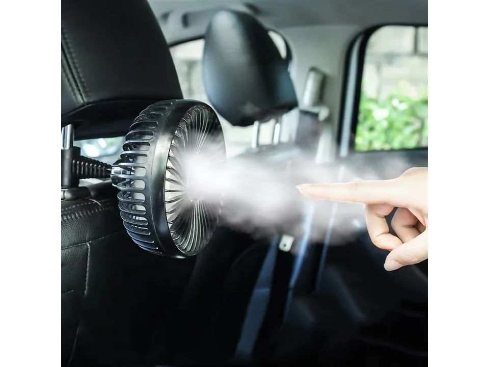Car fan mounted on a headrest emitting a mist.