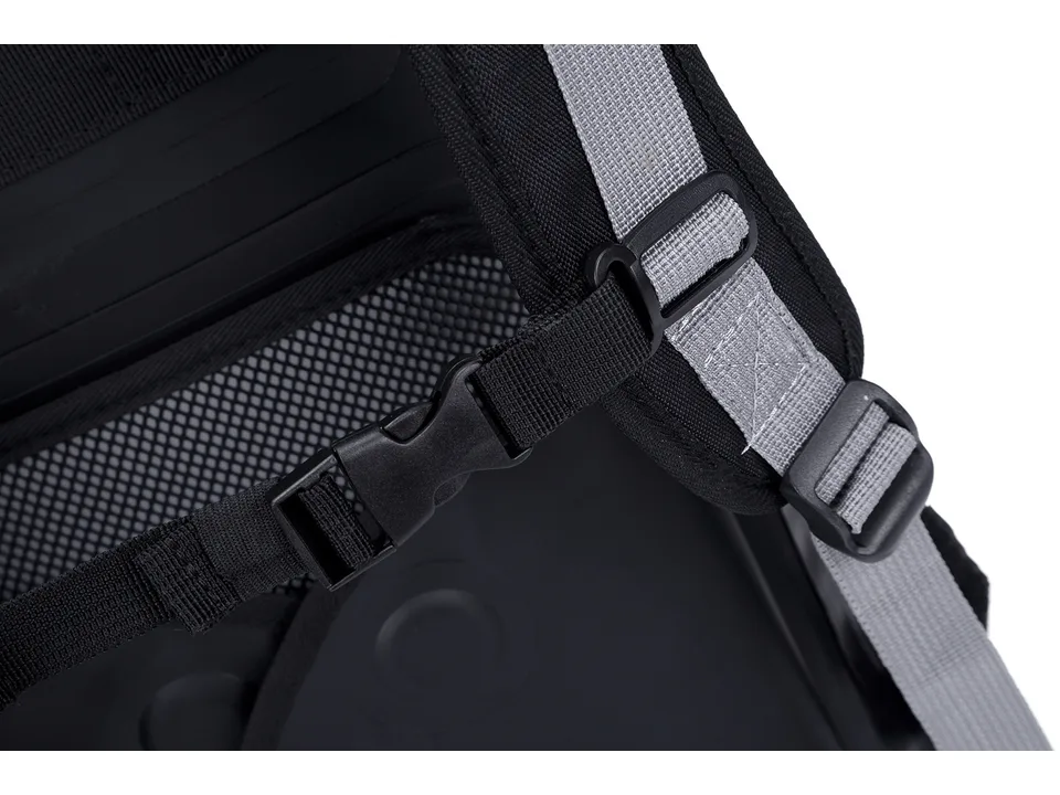 Close-up of the backpack's adjustable shoulder strap and chest buckle.