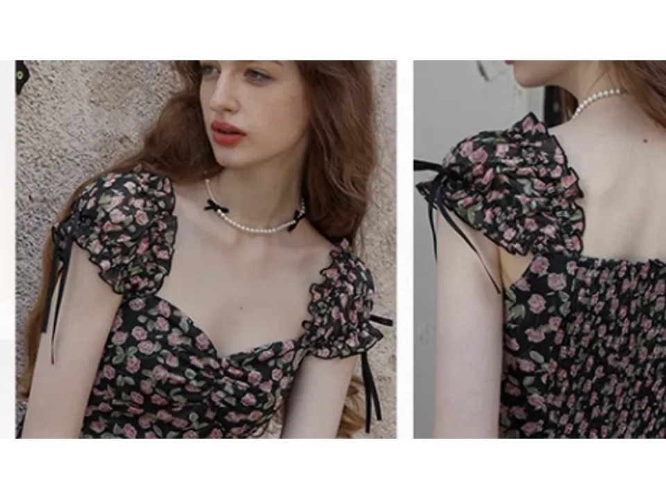 Close-up of the floral dress showing the square neckline and ruffled short sleeves.