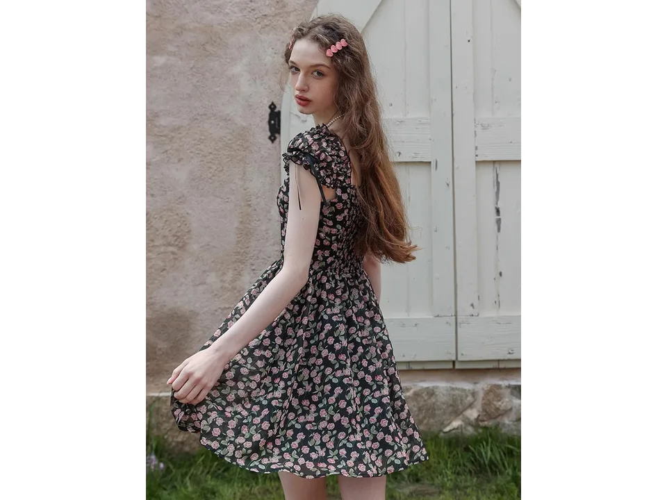 Model wearing the floral midi dress, showing the fit and movement.