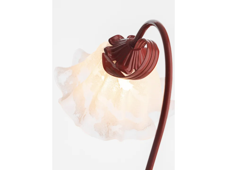 Close-up of the red metal flower lamp base and the frosted glass shade.