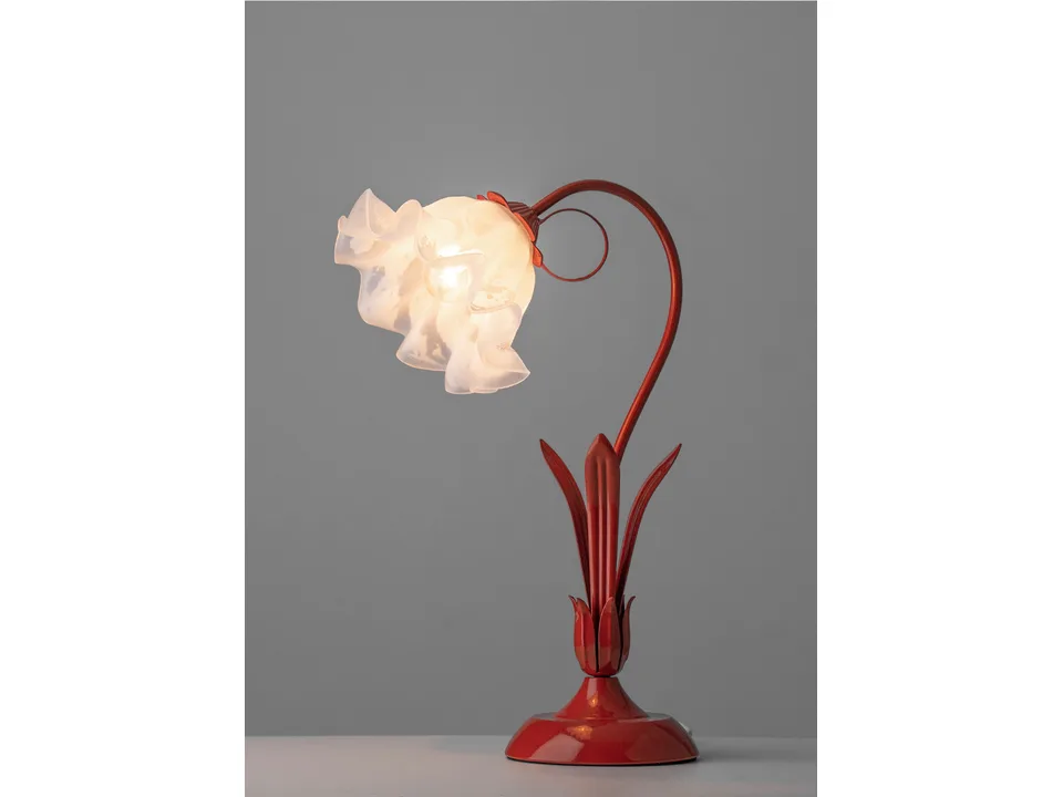 Full view of the red flower bedside lamp with the light turned on.