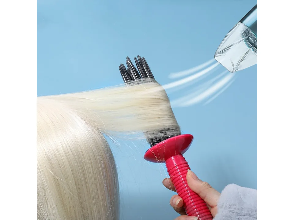 A hand using the hair styling brush on blonde hair with a hair dryer.
