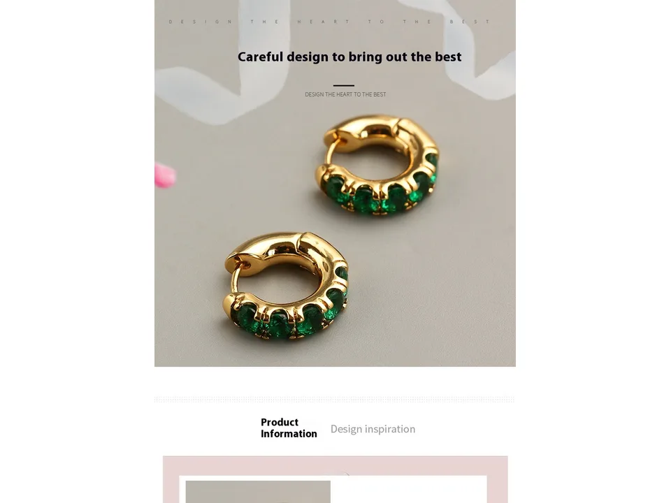 A pair of gold hoop earrings with green stones on a grey background.
