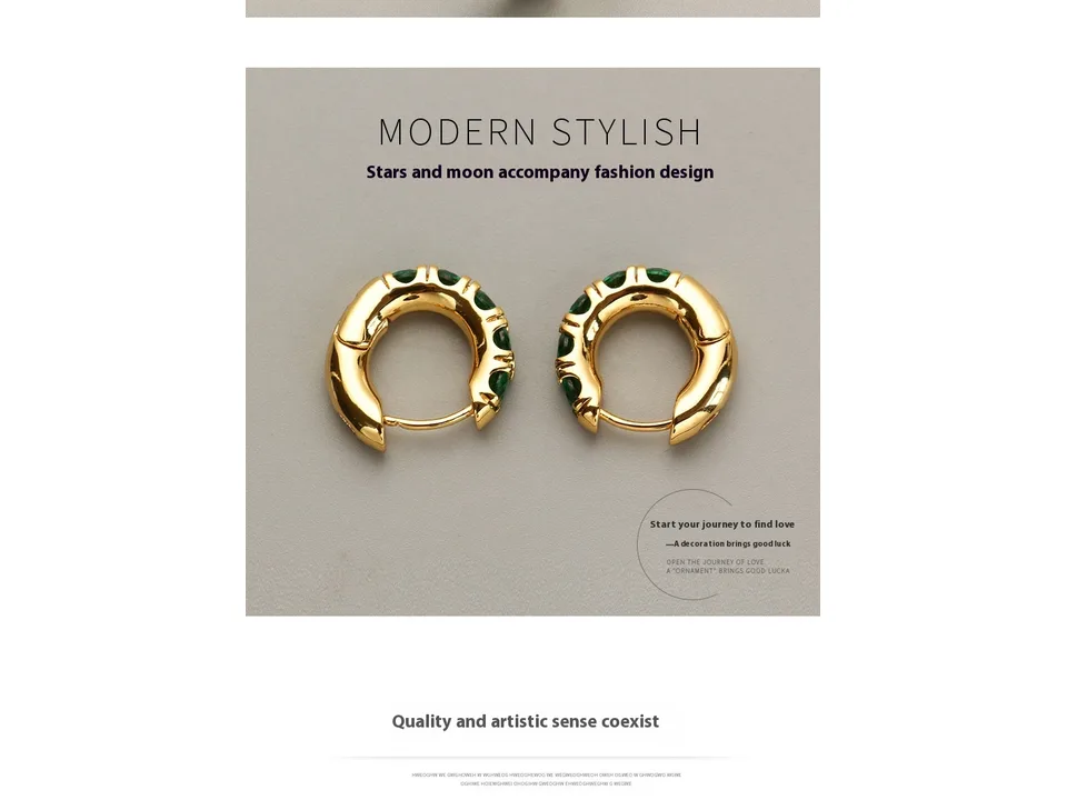 A pair of gold hoop earrings with green stones on a grey background.