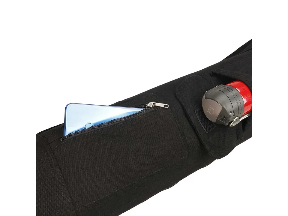 Close-up of the yoga mat bag with a smartphone in the zipper pocket and a water bottle in the flap pocket.