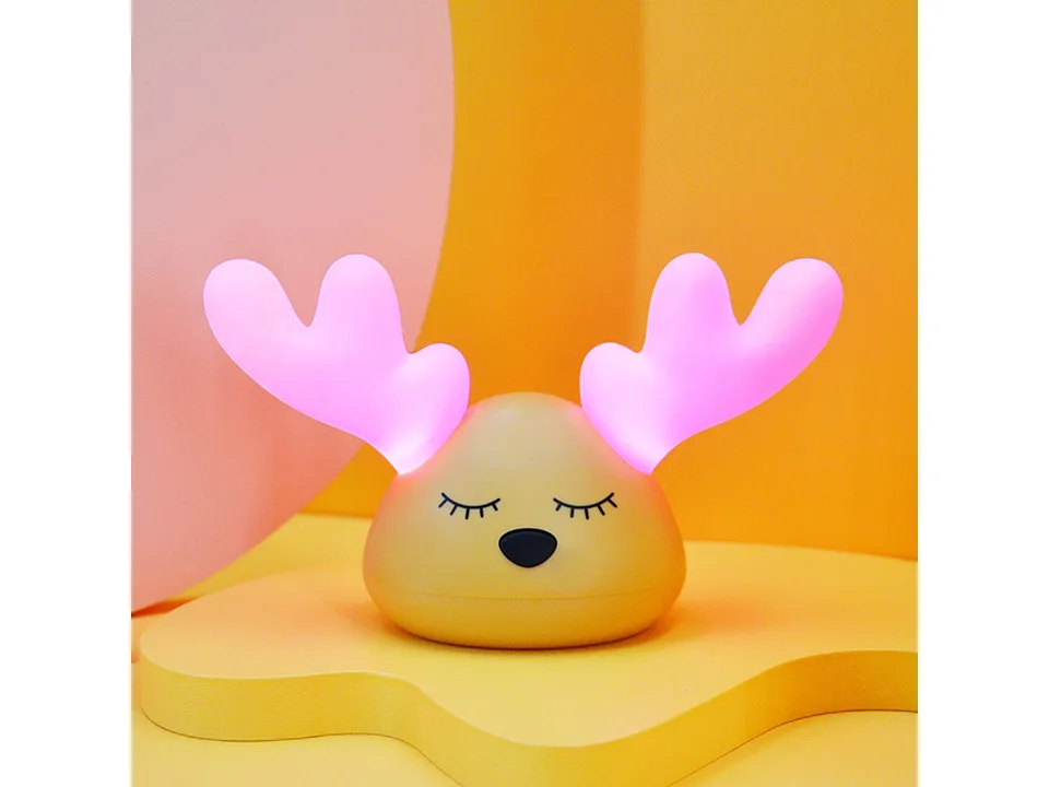 The deer night light glowing with pink light.