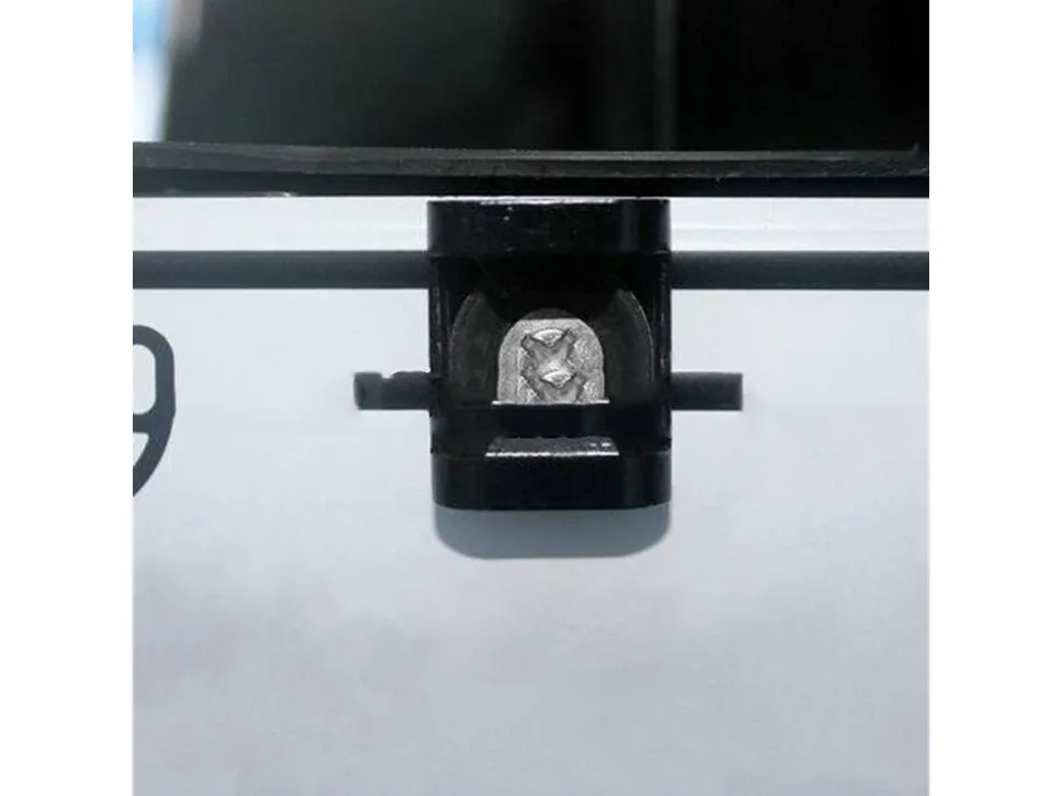 Close-up view of the black bottle opener mounted on a license plate.