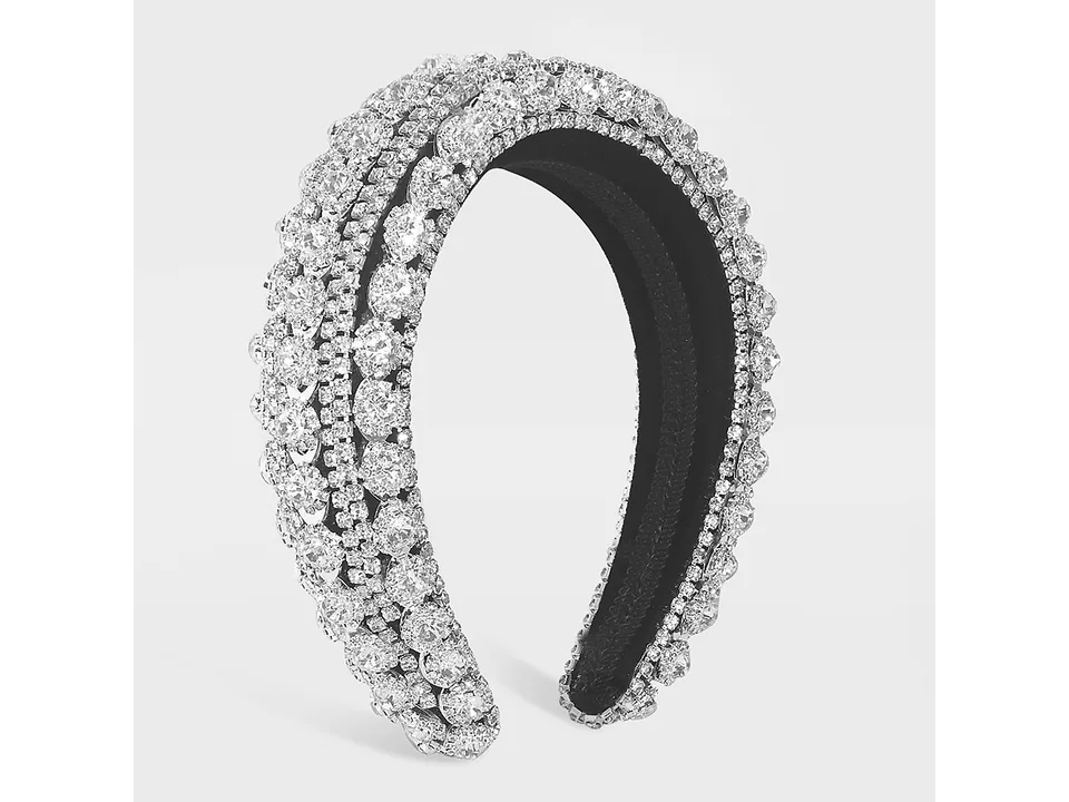 Silver rhinestone headband on a plain background
