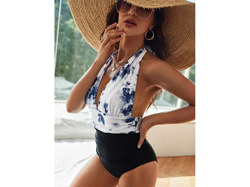 Side view of a woman wearing the floral halter swimsuit.
