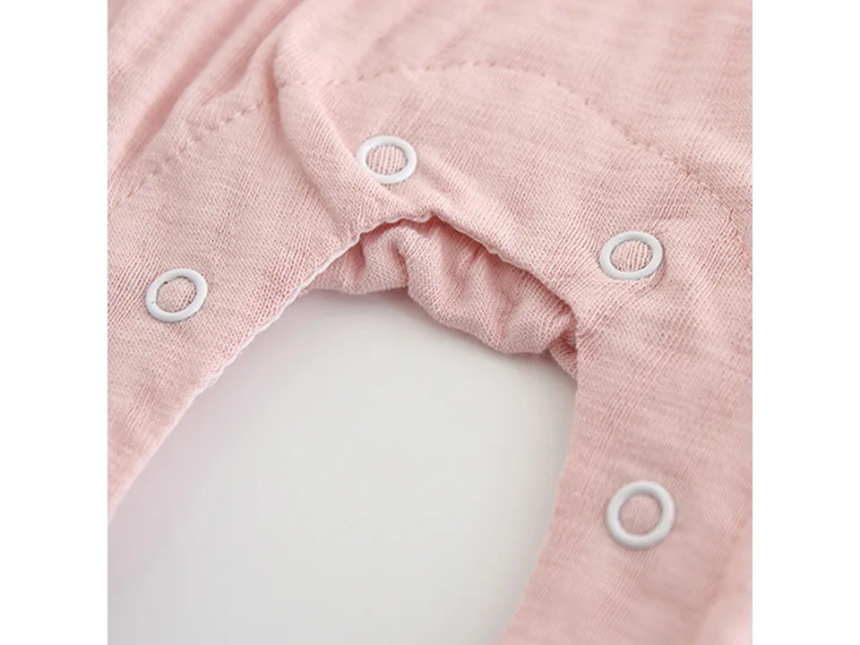 Close-up of the snap buttons and fabric texture on the baby jumpsuit.