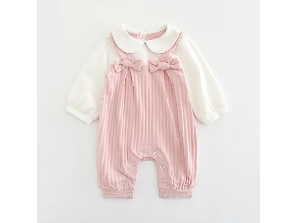 Front view of a pink and white baby jumpsuit with a Peter Pan collar and bow details.