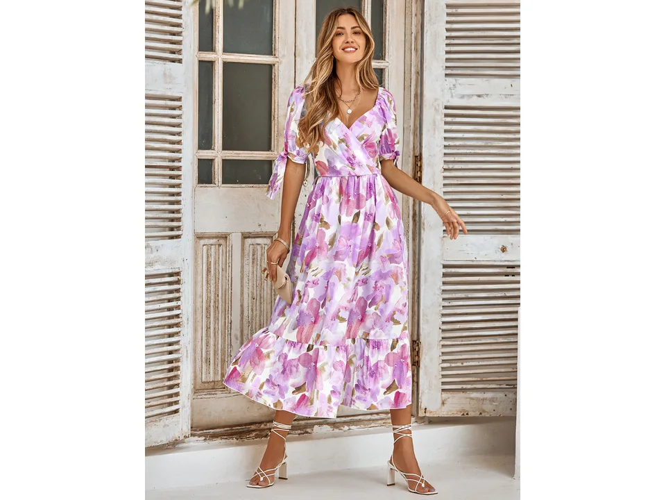 A model wearing the purple floral midi dress with puff sleeves.