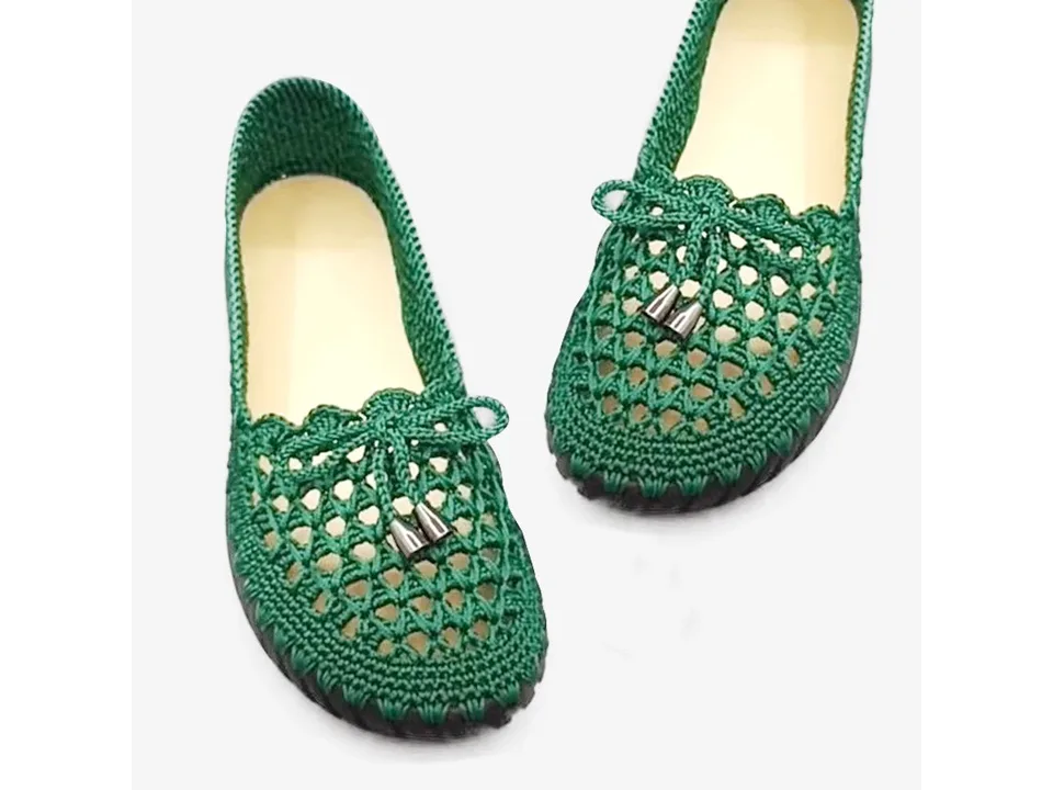 Finished green crocheted slip-on shoes.