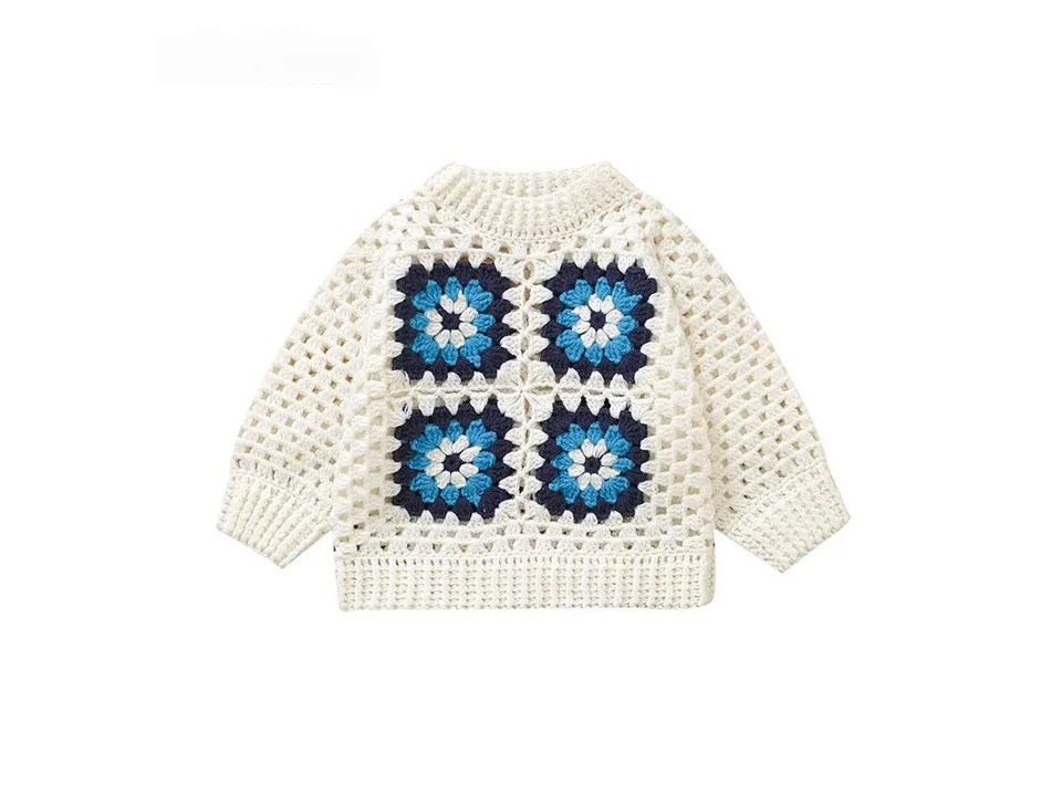A white, blue, and light blue crochet-style knitted sweater for a baby.