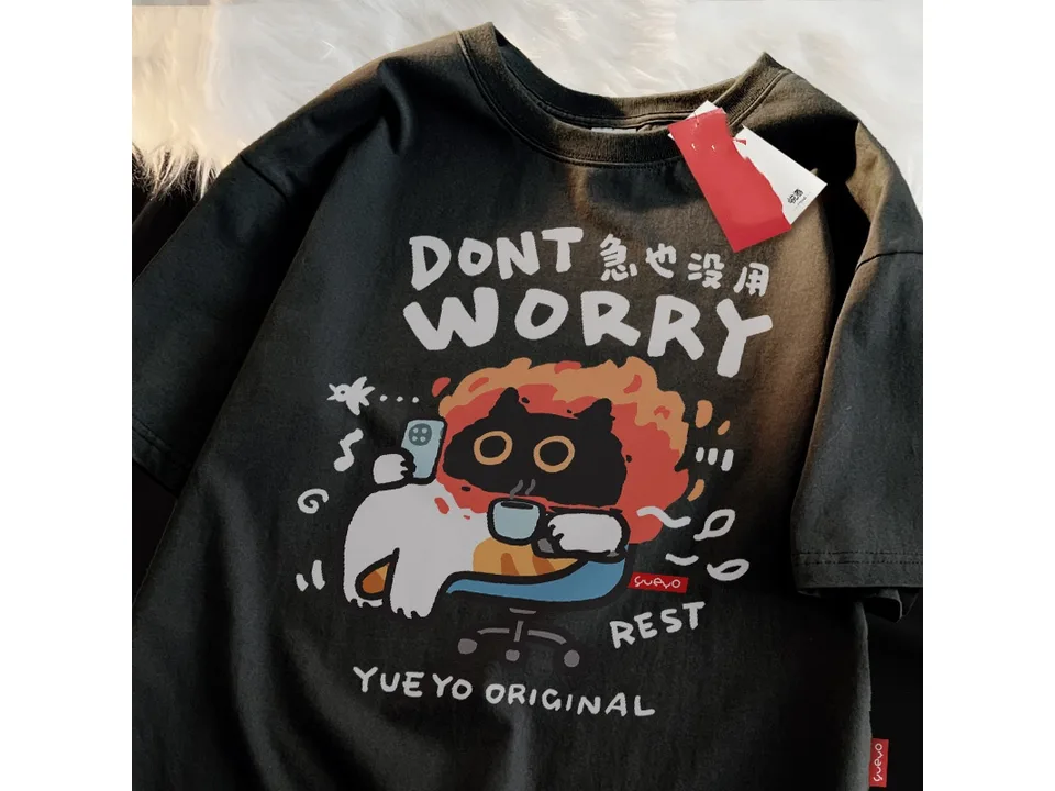Black oversized t-shirt with a graphic of a cat sitting in a chair with a phone and coffee.