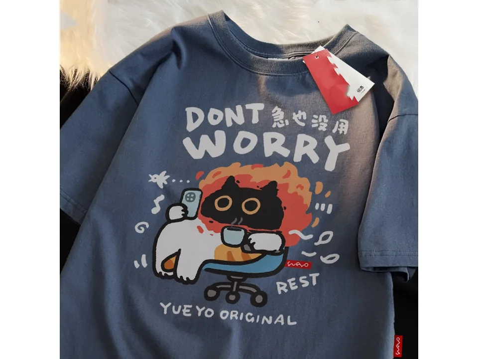 Dark grey oversized t-shirt with a graphic of a cat sitting in a chair with a phone and coffee.