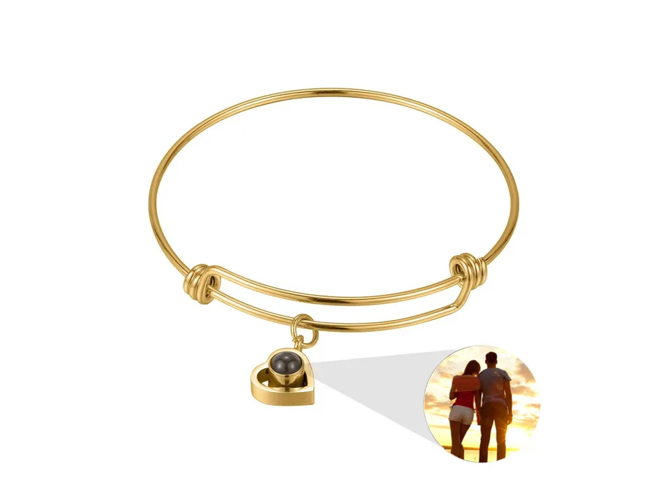 Gold heart-shaped projection bracelet with a sample photo insert.